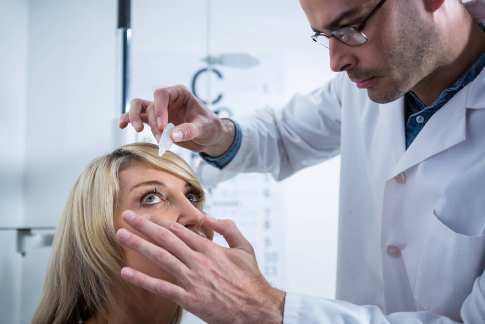 Ophthalmologist administering eye drops to a female patient for dry eye treatment at Moorfields Eye Hospital Dubai
