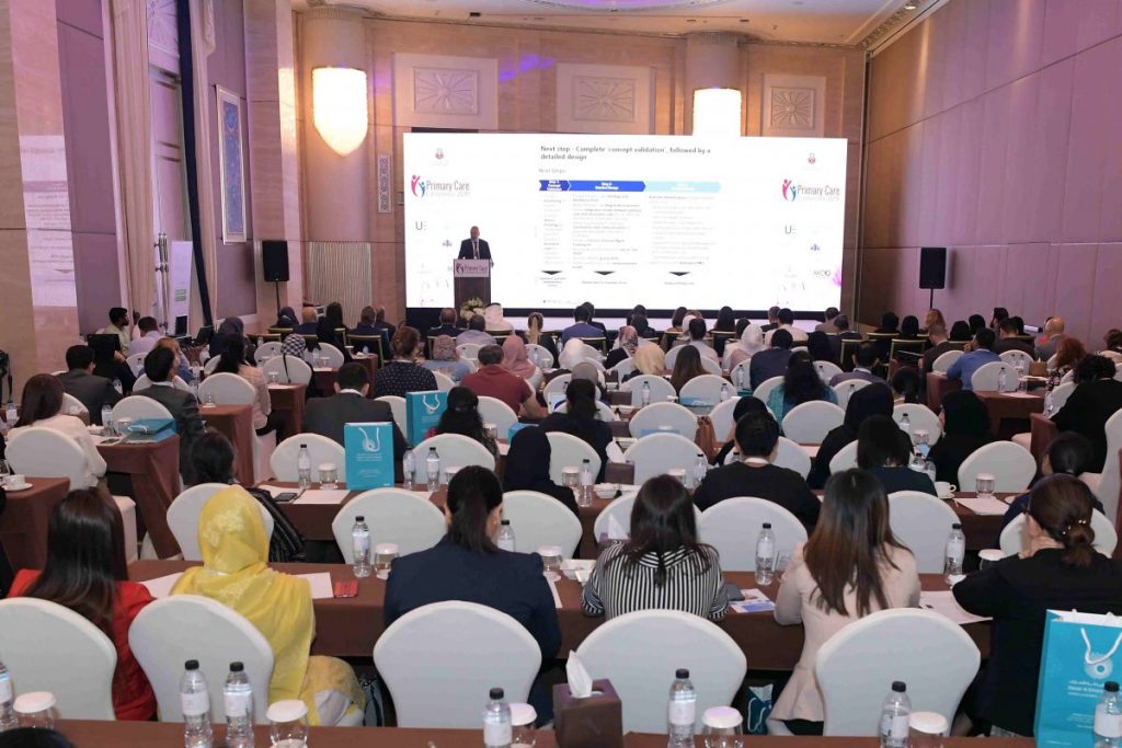 Audience attending a medical conference or seminar in a large ballroom