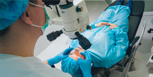 Surgeon performing cataract surgery on a patient using advanced ophthalmic equipment at Moorfields Eye Hospital Dubai.