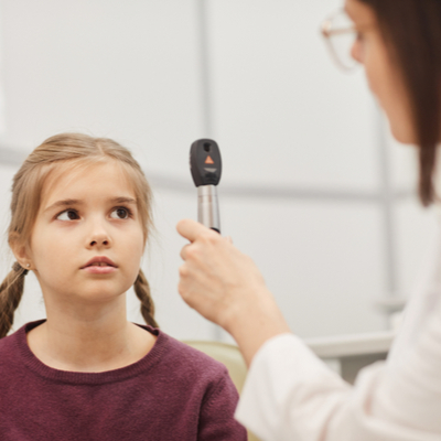 Image of a child undergoing red reflex screening, highlighting paediatric eye care at Moorfields Eye Hospital Dubai